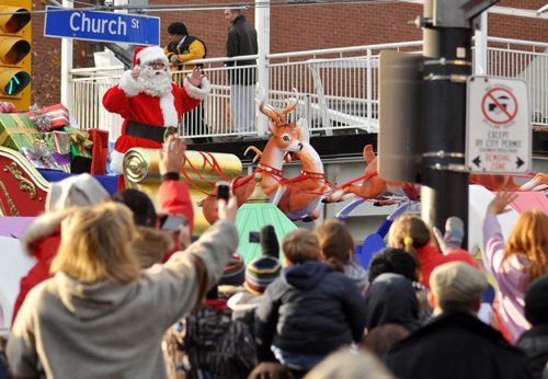 Santa gets cheers and waves as he crosses Church Street.
