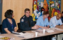 Community response staff sargeant Rudy Pasini gives the police update as CPLC chair Deb Devgan looks on.