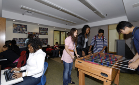 Facilitator Anne (centre) with young people at the Friday night drop-in in the new Youth Room at Yonge St Mission's Gerrard and Parliament facility.